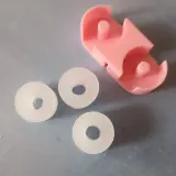 Paraffin wax rings next to a pink wax holder