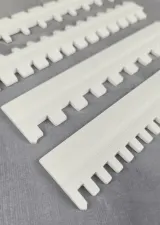White needle selector rulers, close-up of the teeth