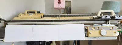 Lower front needle bed cover fitted on a Brother 5gg knitting machine